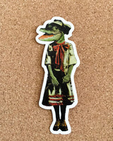 Retro alligator decal on cork background. Alligator is wearing a 1920s style dress.