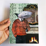 Hand holding handmade shark greeting card. Dressed up animals, illustrated greeting card, illustrated animal card