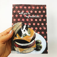 Hand holding a greeting card featuring a boston terrier