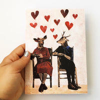 Hand holding illustrated deer greeting card. Deer art. Mixed media animal art.