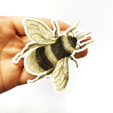 Vintage bee sticker being held