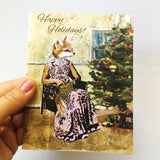Hand holding up a handmade holiday card, illustrated holiday card, fox holiday card, fox Christmas card, text reads "Happy Holidays"