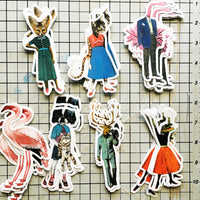 Retro animal stickers on a cutting board. Fancy fox, sassy cat, dapper flamingo, antique flamingo, cute dog, dapper deer, retro alligator stickers