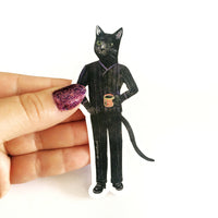 Hand holding a vinyl sticker of a black cat holding a cup of coffee